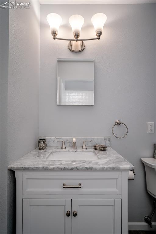 2515 Monterey Road Colorado Springs, CO 80910 - Photo 22 of 32 a bathroom with a granite countertop sink and a mirror