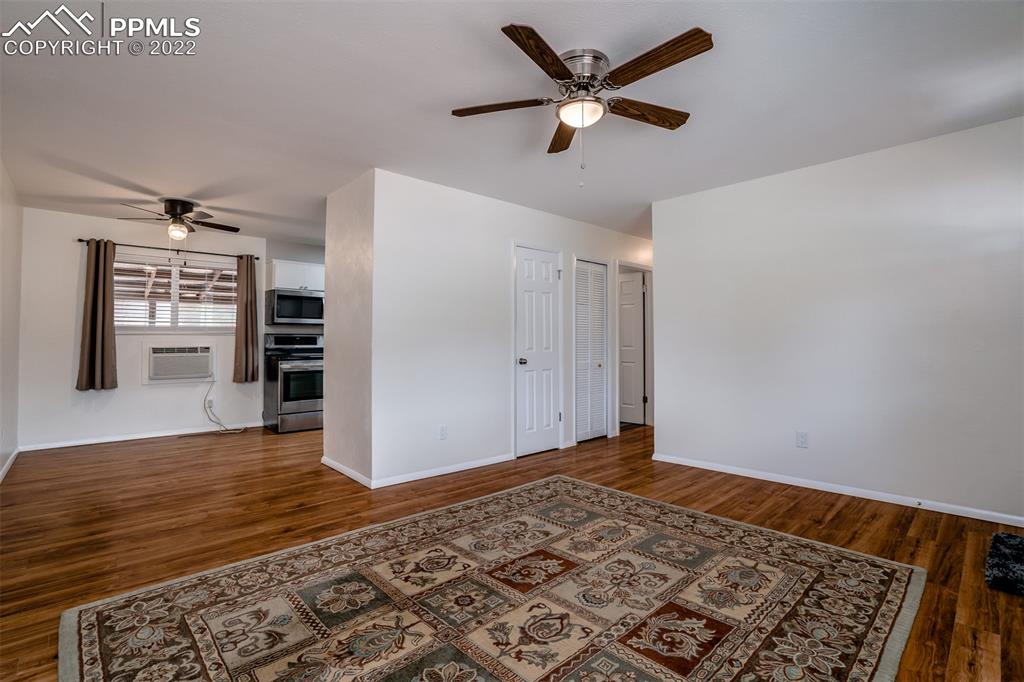 2515 Monterey Road Colorado Springs, CO 80910 - Photo 25 of 32 an empty room with wooden floor closet and ceiling fan