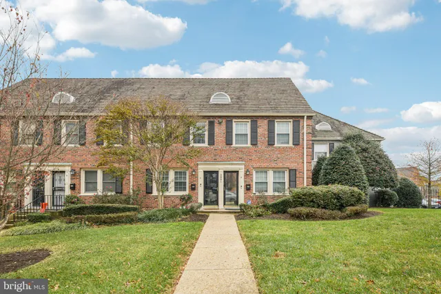 a front view of a residential apartment building with a yard