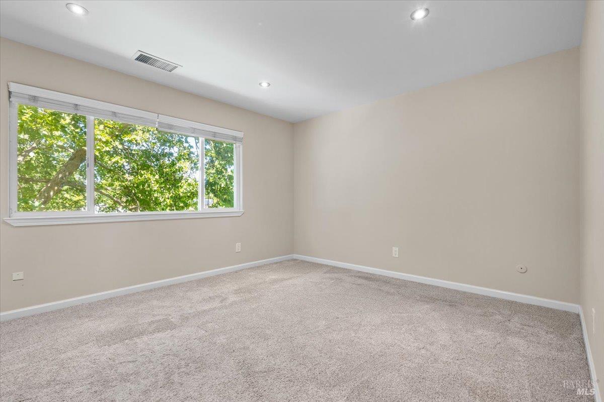 303 Algiers Court Santa Rosa, CA 95409 - Photo 14 of 27 The primary bedroom features and oversize window and more recessed lighting.
