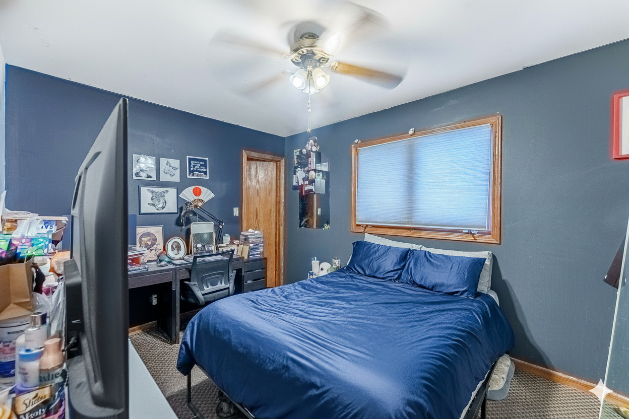 7503 West 58th Place Summit, IL 60501 - Photo 3 of 5 a bedroom with a bed and dresser with wooden floor