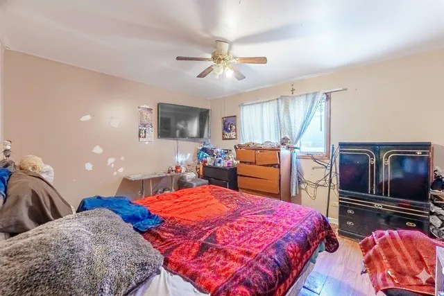a bedroom with a bed and flat screen tv