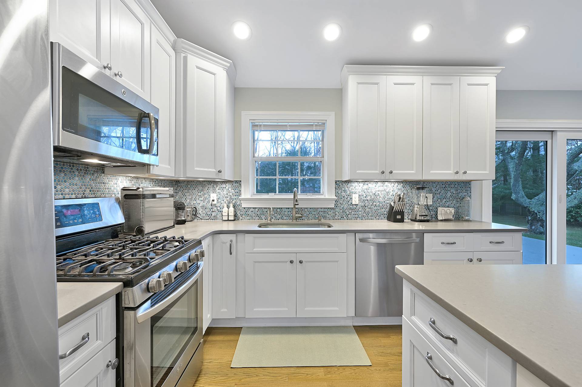 25 Nidzyn Avenue Remsenburg, NY 11960 - Photo 12 of 32 a kitchen with a white cabinets and appliances