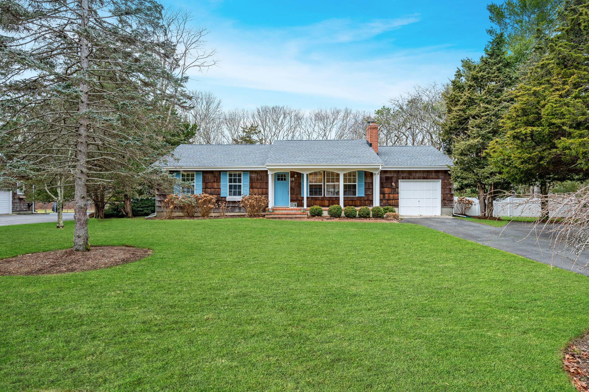 25 Nidzyn Avenue Remsenburg, NY 11960 - Photo 2 of 32 a front view of a house with a yard