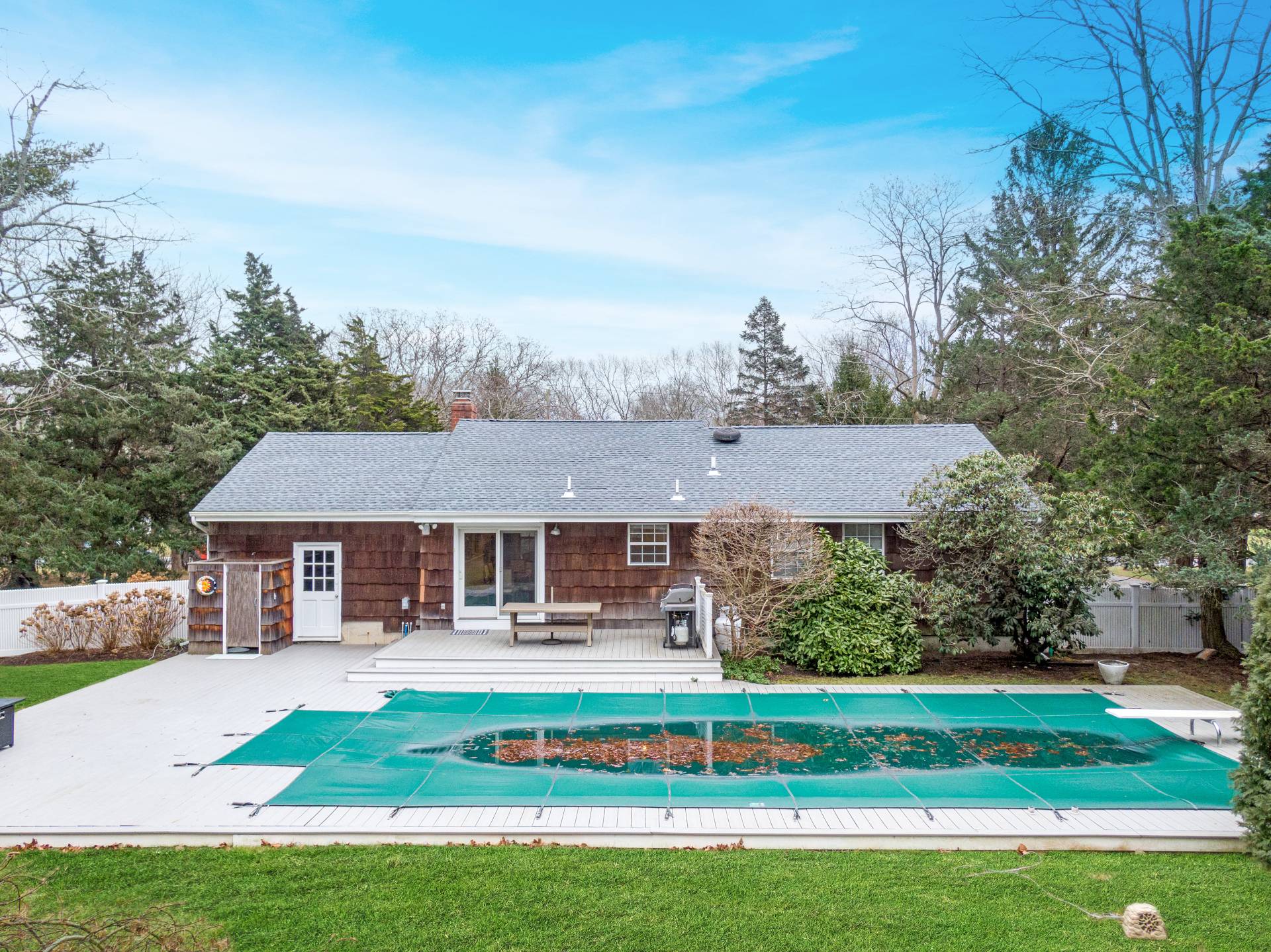 25 Nidzyn Avenue Remsenburg, NY 11960 - Photo 26 of 32 a front view of a house with a yard table and chairs
