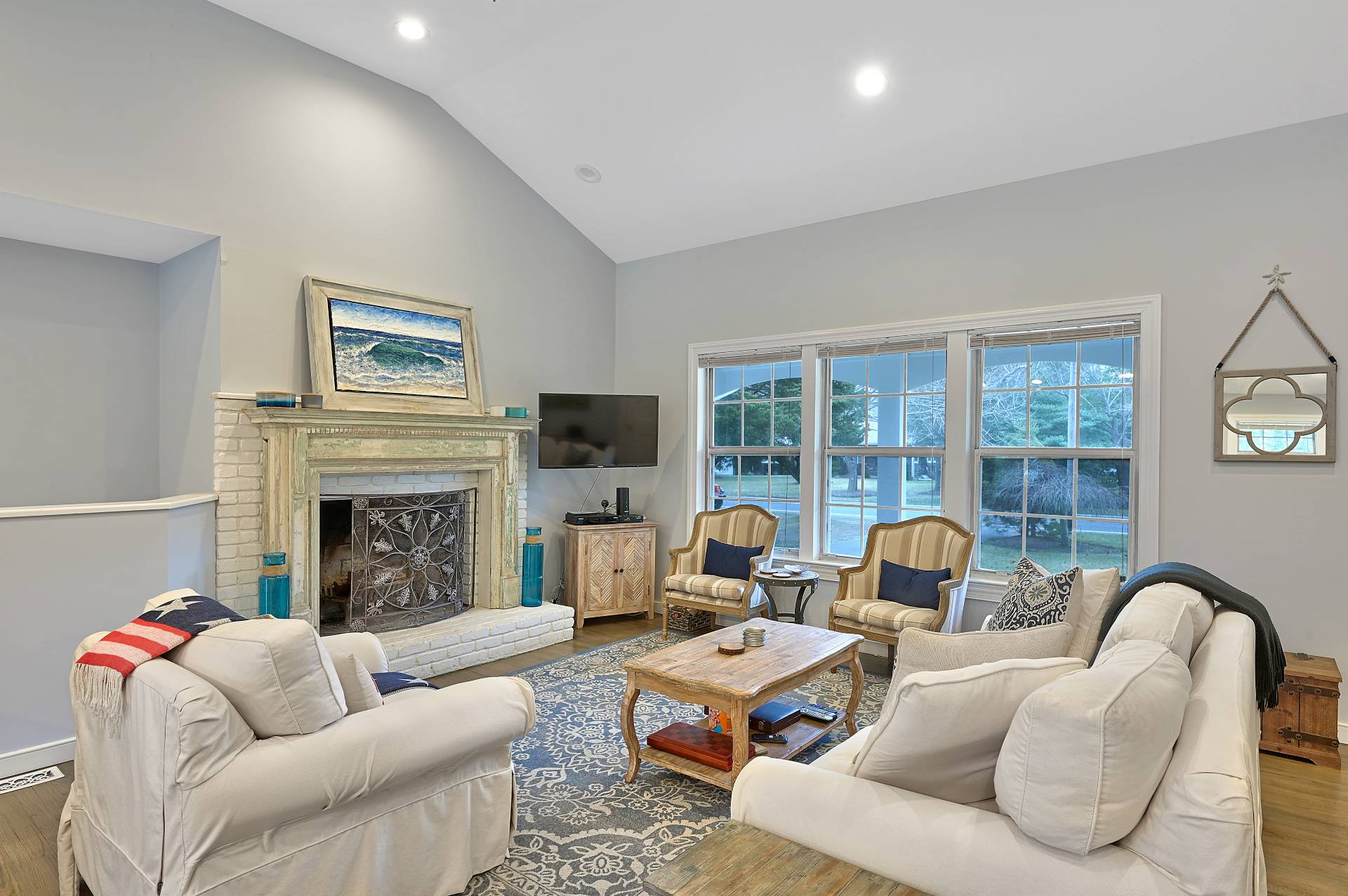 25 Nidzyn Avenue Remsenburg, NY 11960 - Photo 4 of 32 a living room with furniture fireplace and a large window