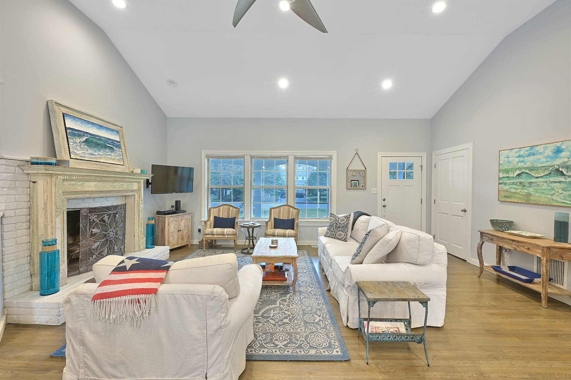25 Nidzyn Avenue Remsenburg, NY 11960 - Photo 6 of 32 a living room with fireplace furniture and a wooden floor