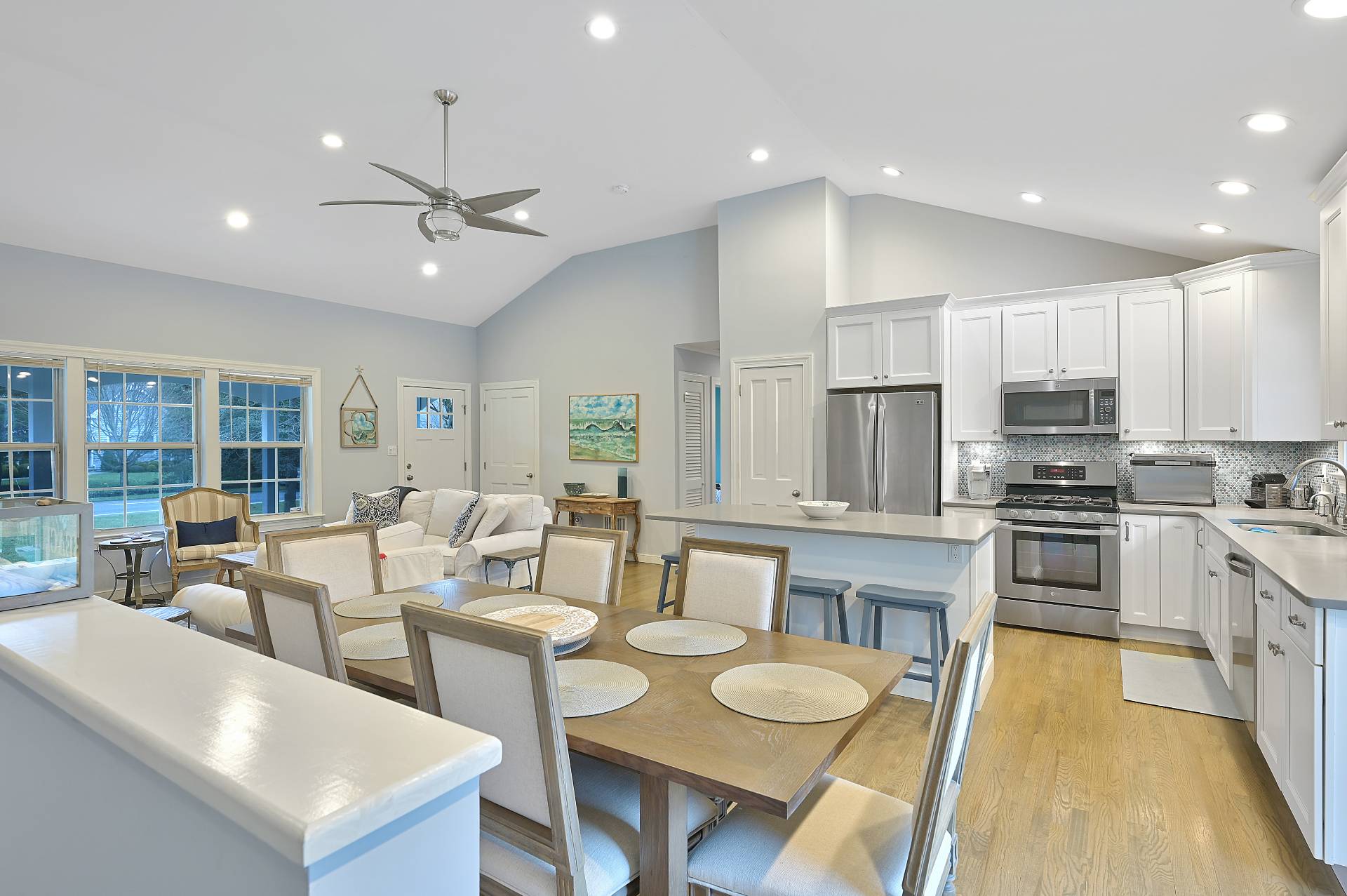 25 Nidzyn Avenue Remsenburg, NY 11960 - Photo 8 of 32 a large kitchen with kitchen island granite countertop a stove a sink a dining table and chairs