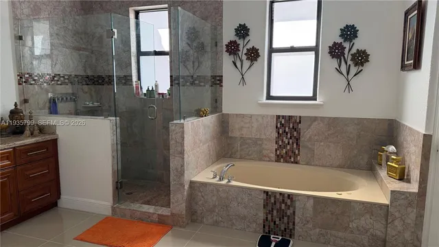 a bathroom with a tub and a shower