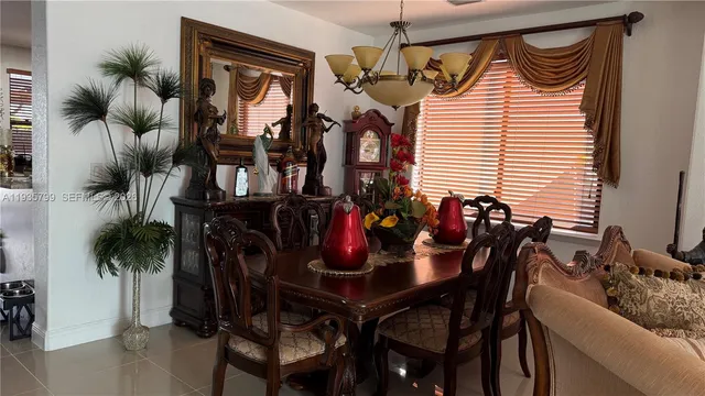 a view of a dining room with furniture and chandelier