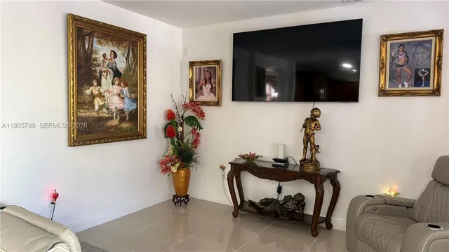 a living room with furniture and flowers