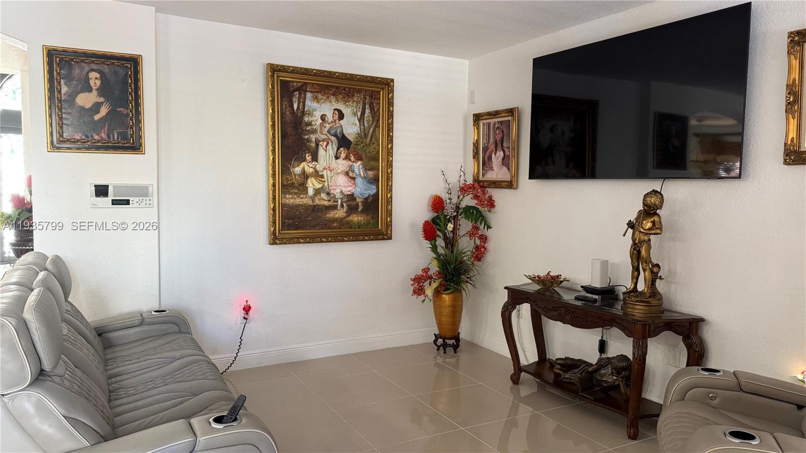 14431 Southwest 22nd Terrace Miami, FL 33175 - Photo 8 of 17 a living room with furniture and a flat screen tv