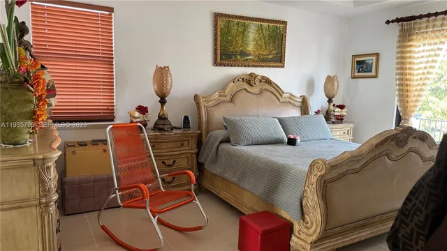 a bed room with a bed and a chair