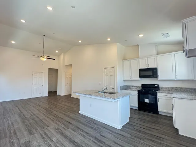 a kitchen with a sink and a refrigerator