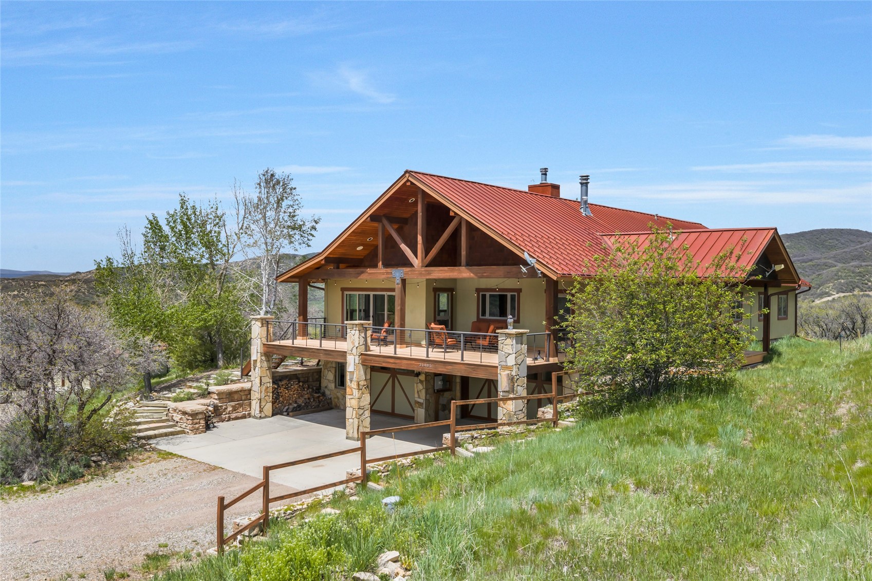 31485 Deerwood Ranch Road Steamboat Springs, CO 80487 - Photo 3 of 49 a front view of a house with a yard
