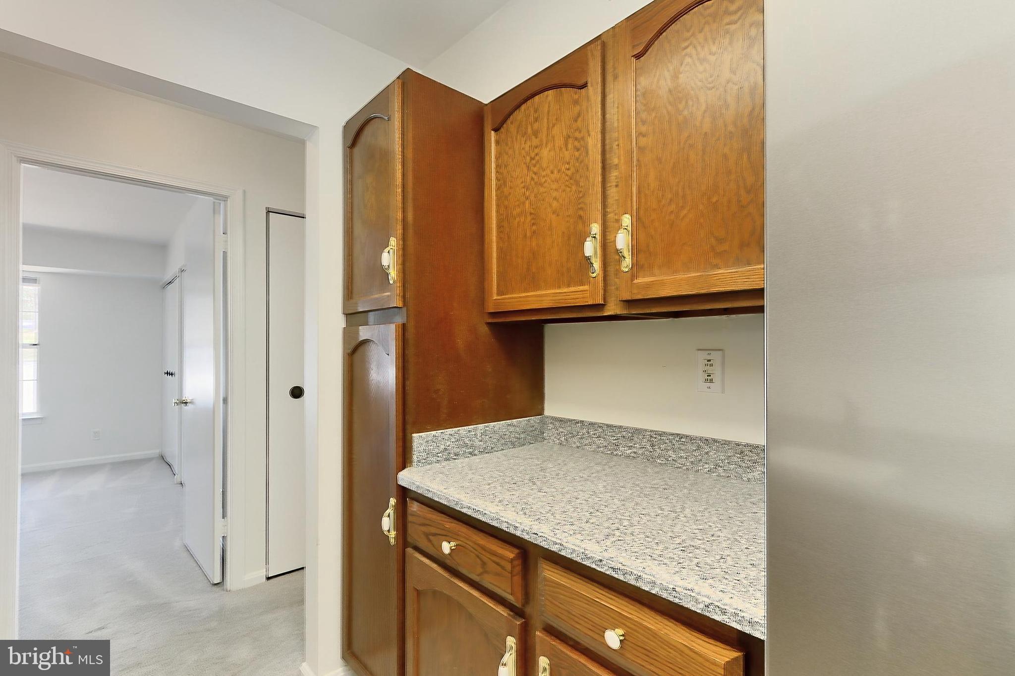 5912 Cove Landing Road, Unit 204 Burke, VA 22015 - Photo 19 of 42 a kitchen with granite countertop cabinets and black appliances