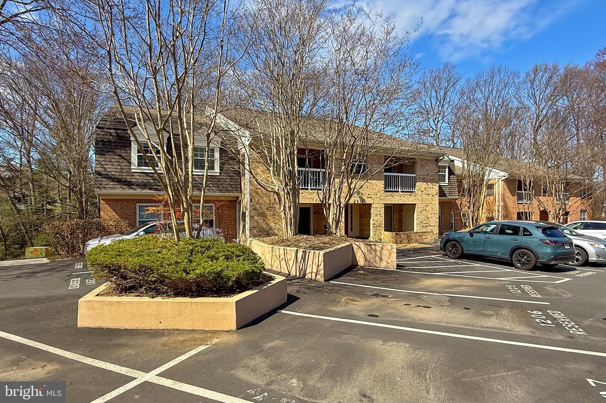 5912 Cove Landing Road, Unit 204 Burke, VA 22015 - Photo 3 of 42 a view of a car park in front of a building
