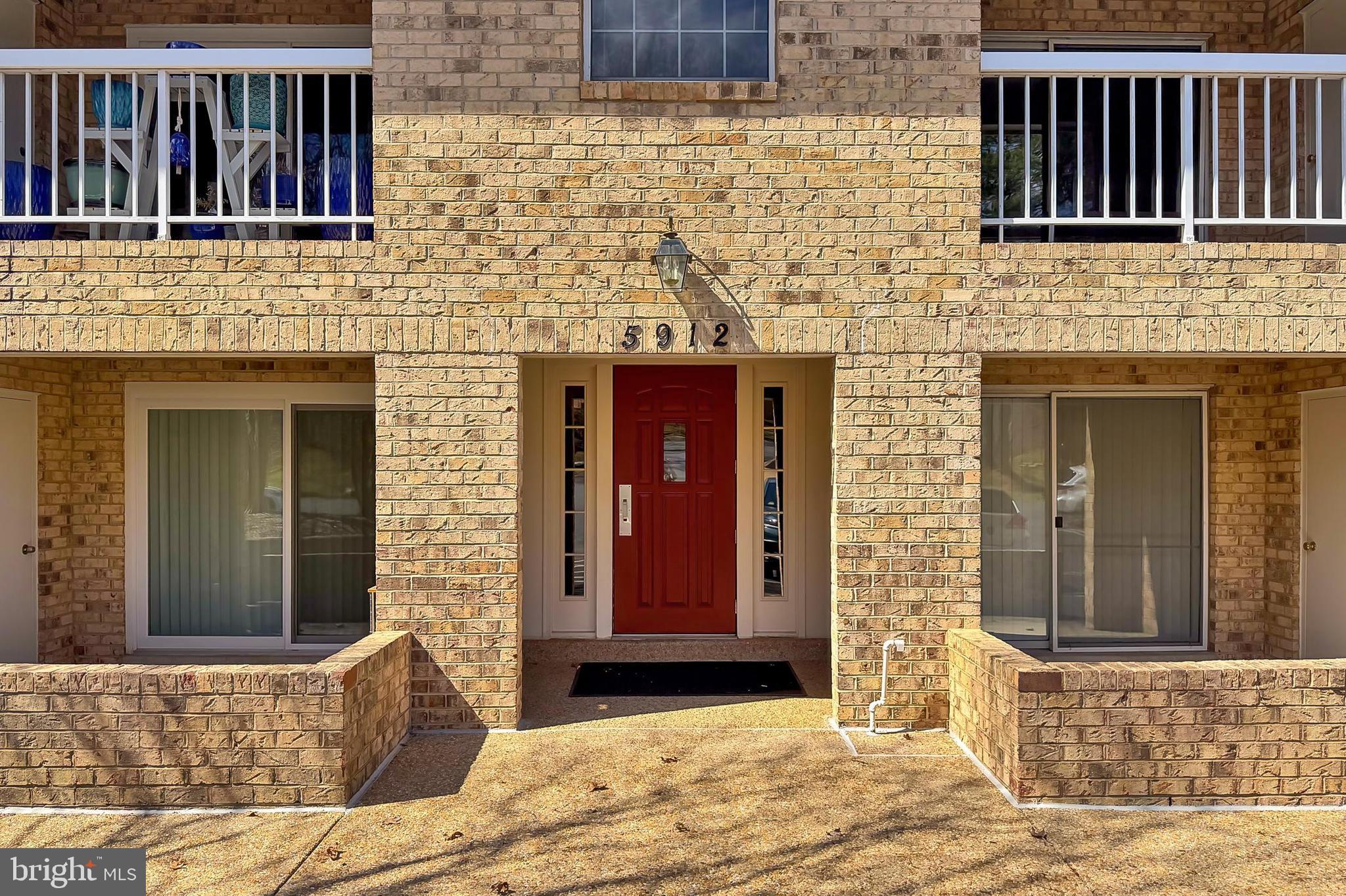 5912 Cove Landing Road, Unit 204 Burke, VA 22015 - Photo 6 of 42 a front view of a house with a yard