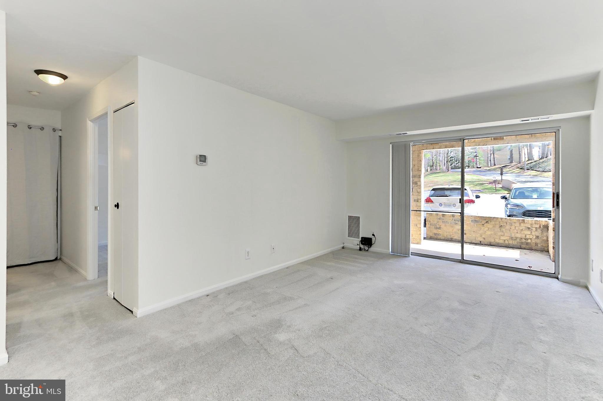 5912 Cove Landing Road, Unit 204 Burke, VA 22015 - Photo 9 of 42 an empty room with sliding door and natural light