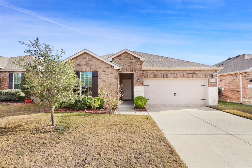 a front view of a house with a yard and potted plants