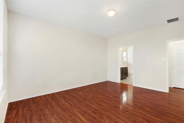 a big room with wooden floor and windows