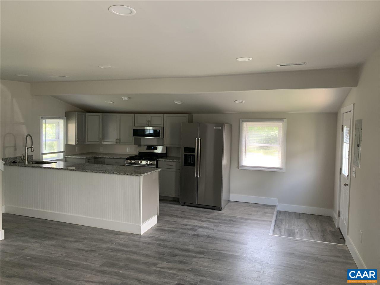 1109 Myrtle Street, Unit B Charlottesville, VA 22902 - Photo 5 of 14 a kitchen with stainless steel appliances granite countertop a refrigerator and a sink