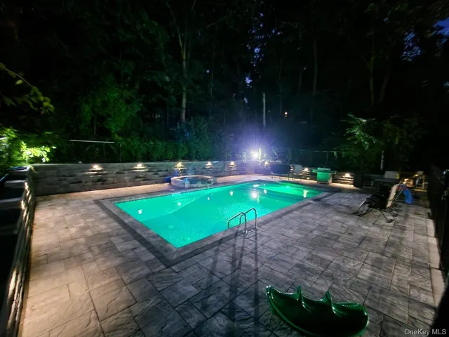 a view of a backyard with plants and a patio