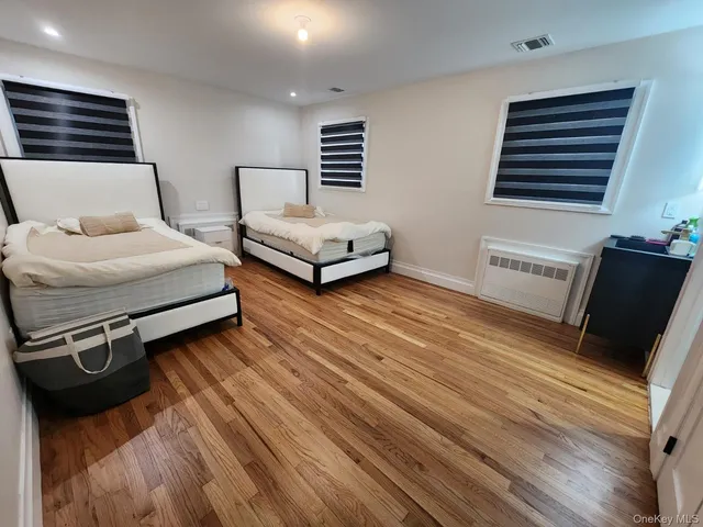 a bedroom with two beds and a couch