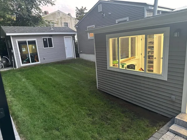 a view of a house with a backyard