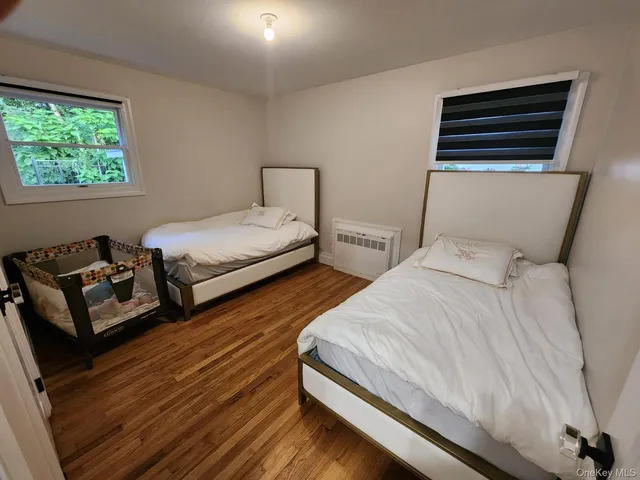 a bedroom with two beds and a window