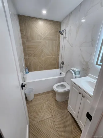 a bathroom with a sink a toilet a mirror and shower