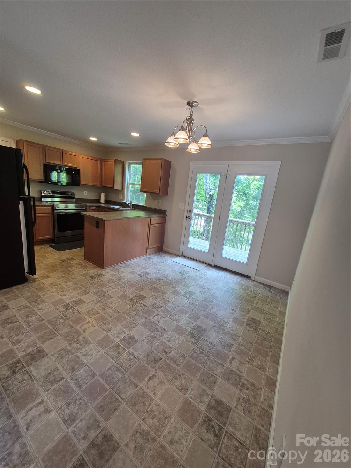 149 Alpine Ridge Drive Asheville, NC 28803 - Photo 8 of 15 a view of kitchen with kitchen island granite countertop a refrigerator a sink a stove a dining table and chairs