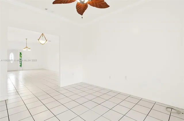 a kitchen with granite countertop a refrigerator a stove top oven a sink and dishwasher