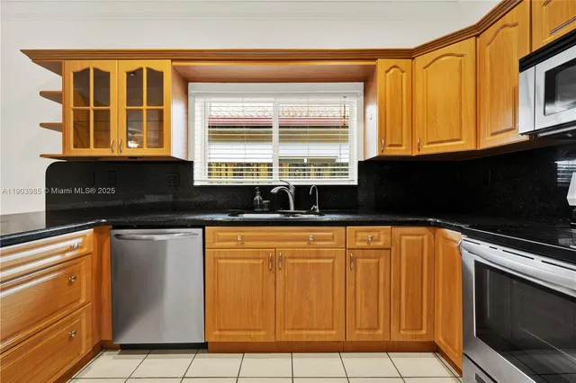 a kitchen with granite countertop a sink and a stove