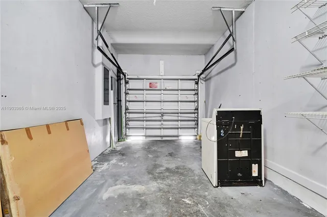 a view of a tennis ground with large trees