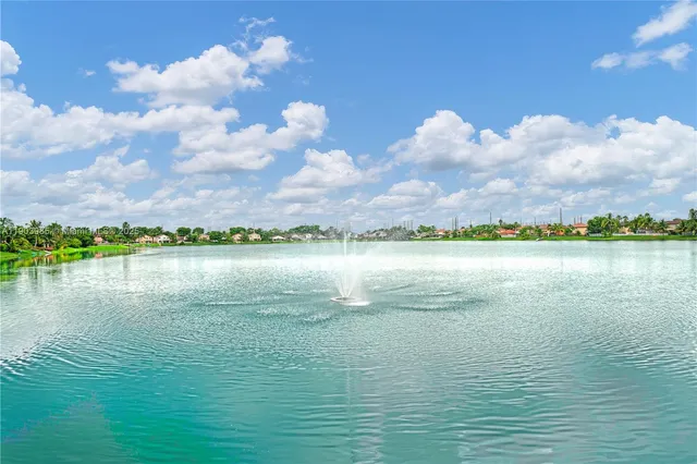 a living room with furniture a chandelier and a dining table