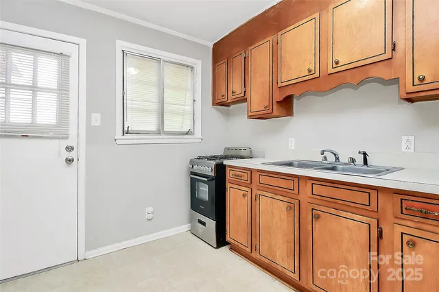 a spacious bathroom with stainless steel appliances granite countertop a sink and a window