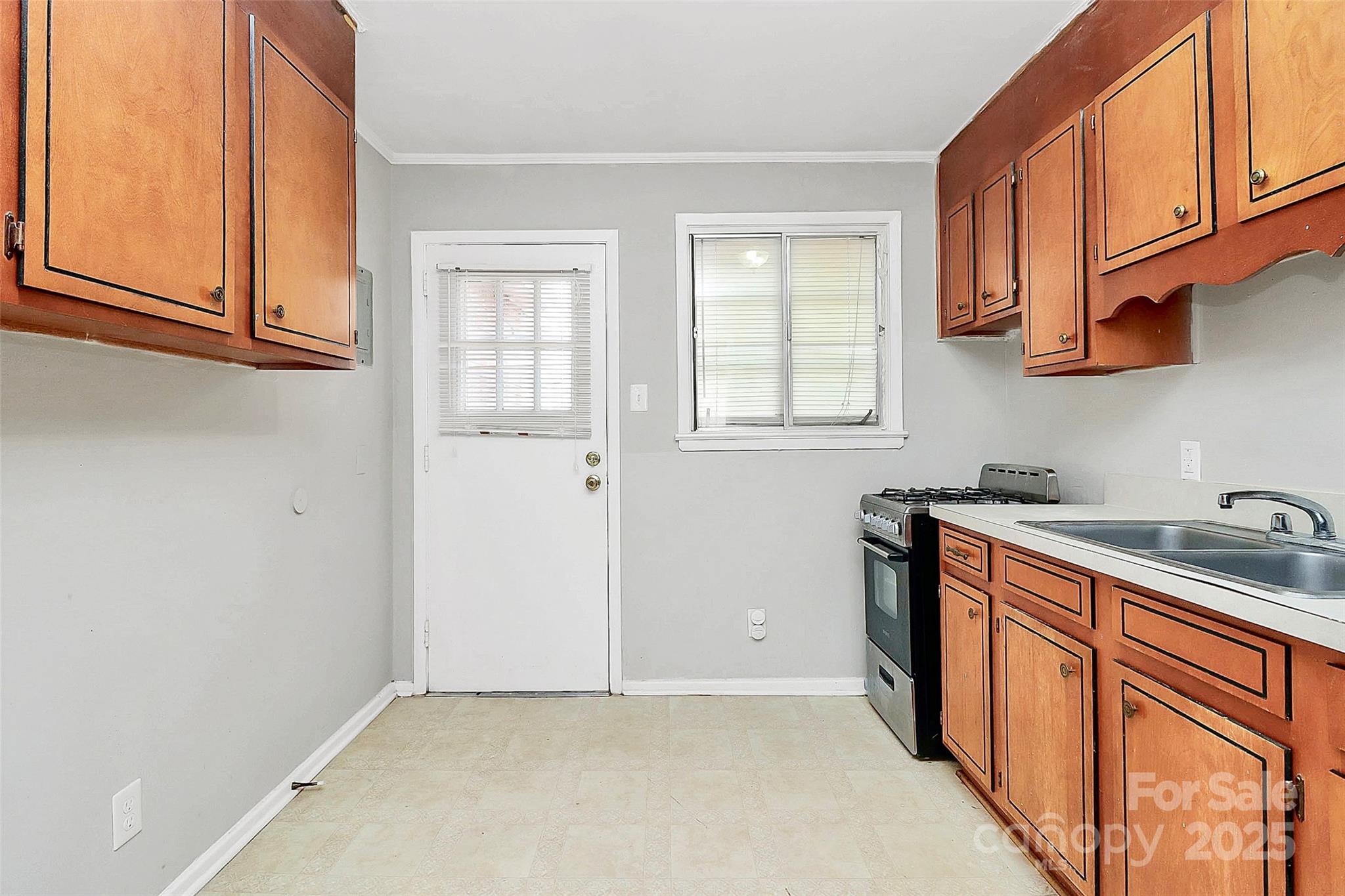 3210 Minnesota Road Charlotte, NC 28208 - Photo 16 of 20 a kitchen with stainless steel appliances granite countertop a sink stove and cabinets