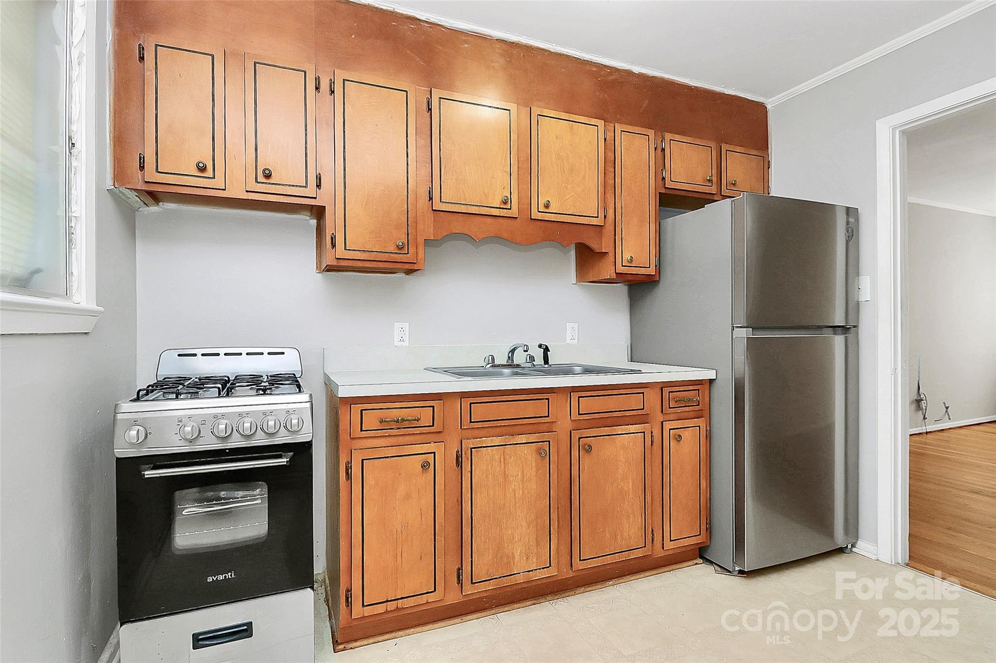 3210 Minnesota Road Charlotte, NC 28208 - Photo 3 of 20 a kitchen with stainless steel appliances granite countertop a refrigerator sink and stove
