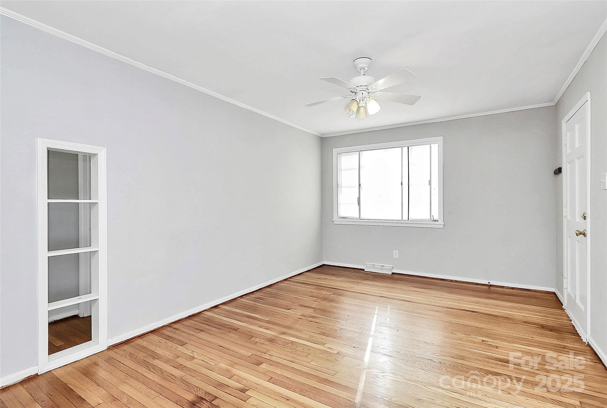 3210 Minnesota Road Charlotte, NC 28208 - Photo 6 of 20 a view of empty room with wooden floor and fan