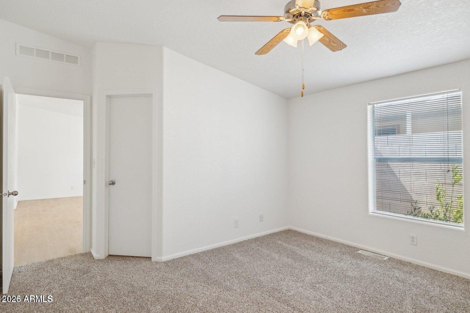 16101 North El Mirage Road, Unit 327 El Mirage, AZ 85335 - Photo 14 of 19 an empty room with a window and a fan