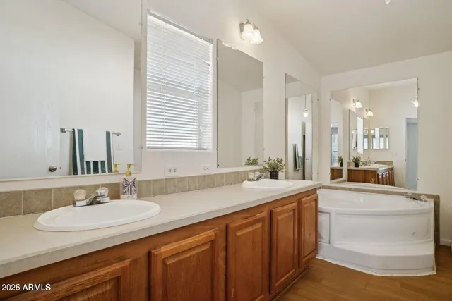 a bathroom with a sink double vanity granite and a mirror