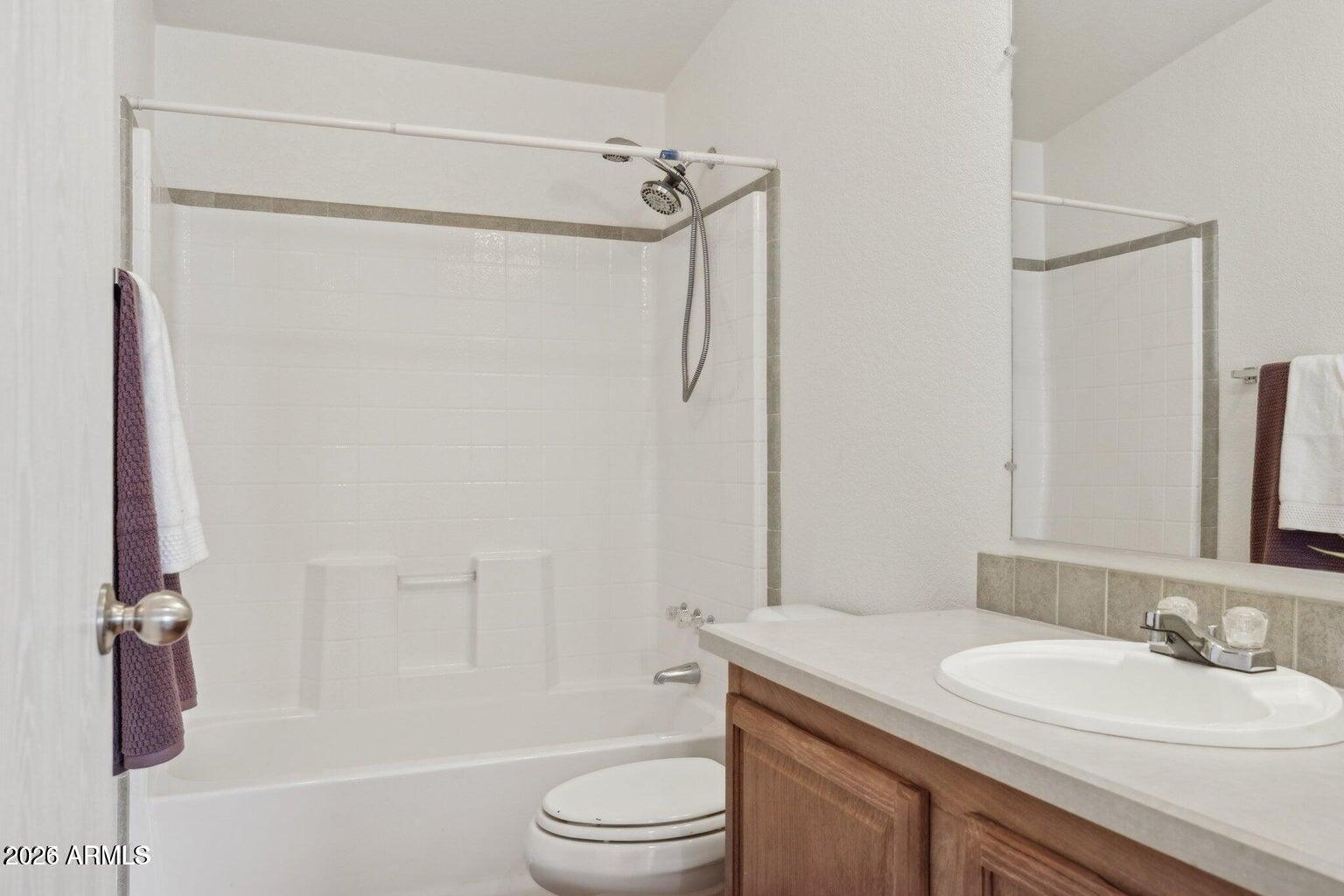 16101 North El Mirage Road, Unit 327 El Mirage, AZ 85335 - Photo 17 of 19 a bathroom with a granite countertop sink toilet and shower