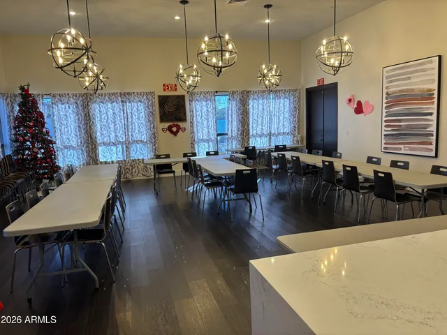 a large dining space with furniture window and wooden floor