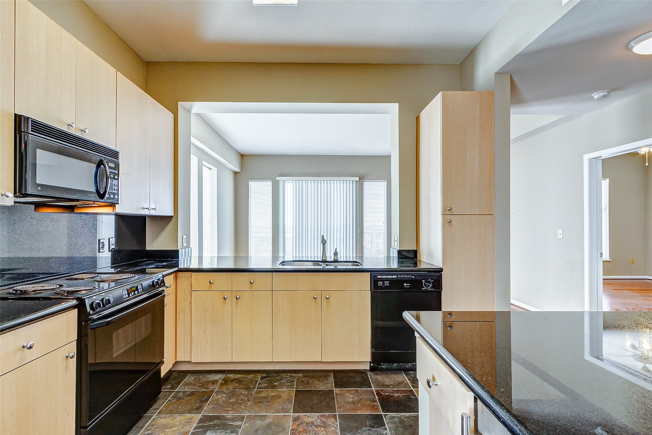 3505 Sage Road, Unit 1702 Houston, TX 77056 - Photo 19 of 23 a kitchen with granite countertop a stove and a sink