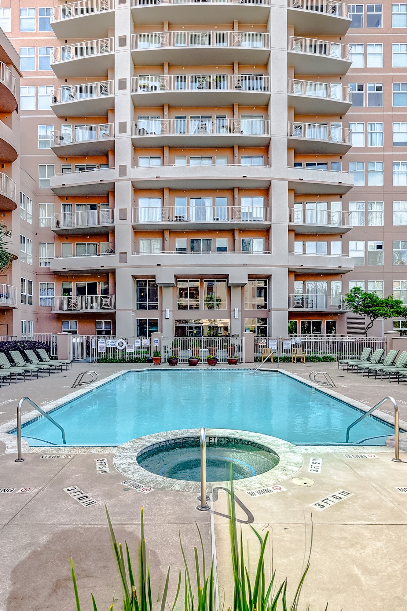 3505 Sage Road, Unit 1702 Houston, TX 77056 - Photo 4 of 23 a view of a swimming pool with a lounge chairs