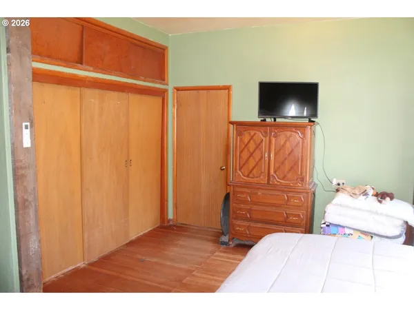 a bedroom with a bed and a television