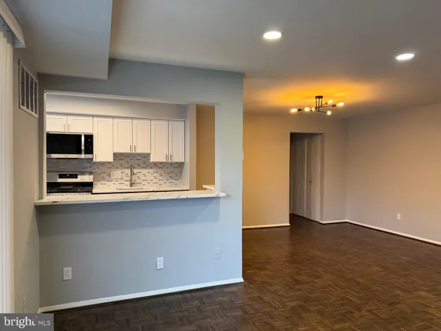 a kitchen with stainless steel appliances a sink stove and microwave