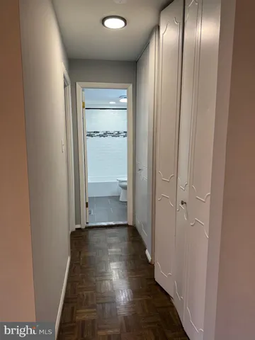 a view of a room with wooden floor