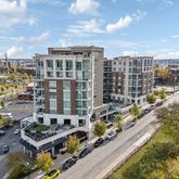 a kitchen with kitchen island wooden floors appliances and cabinets